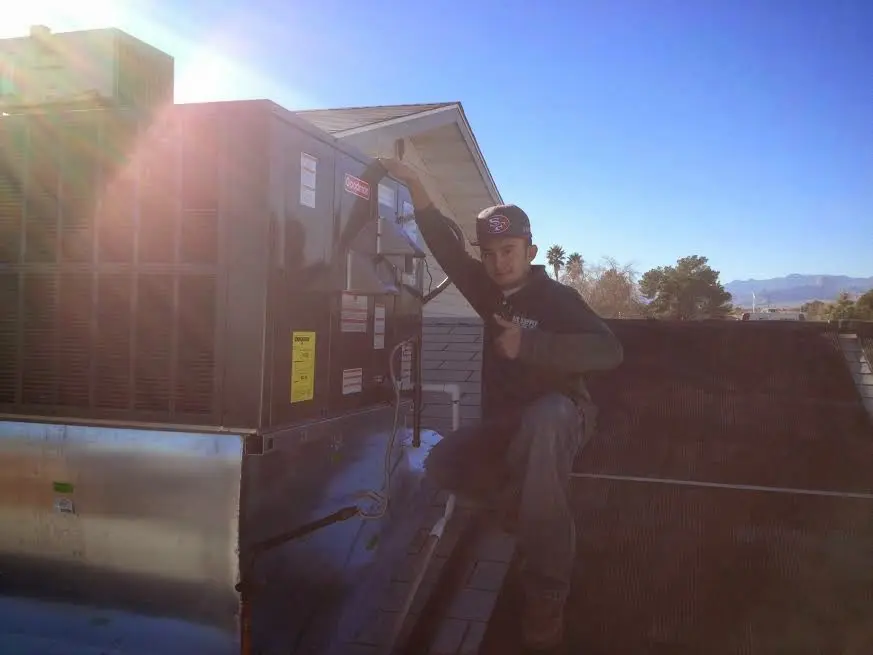 HVAC technician performing Air Duct Repair on a rooftop unit in Mamakating
